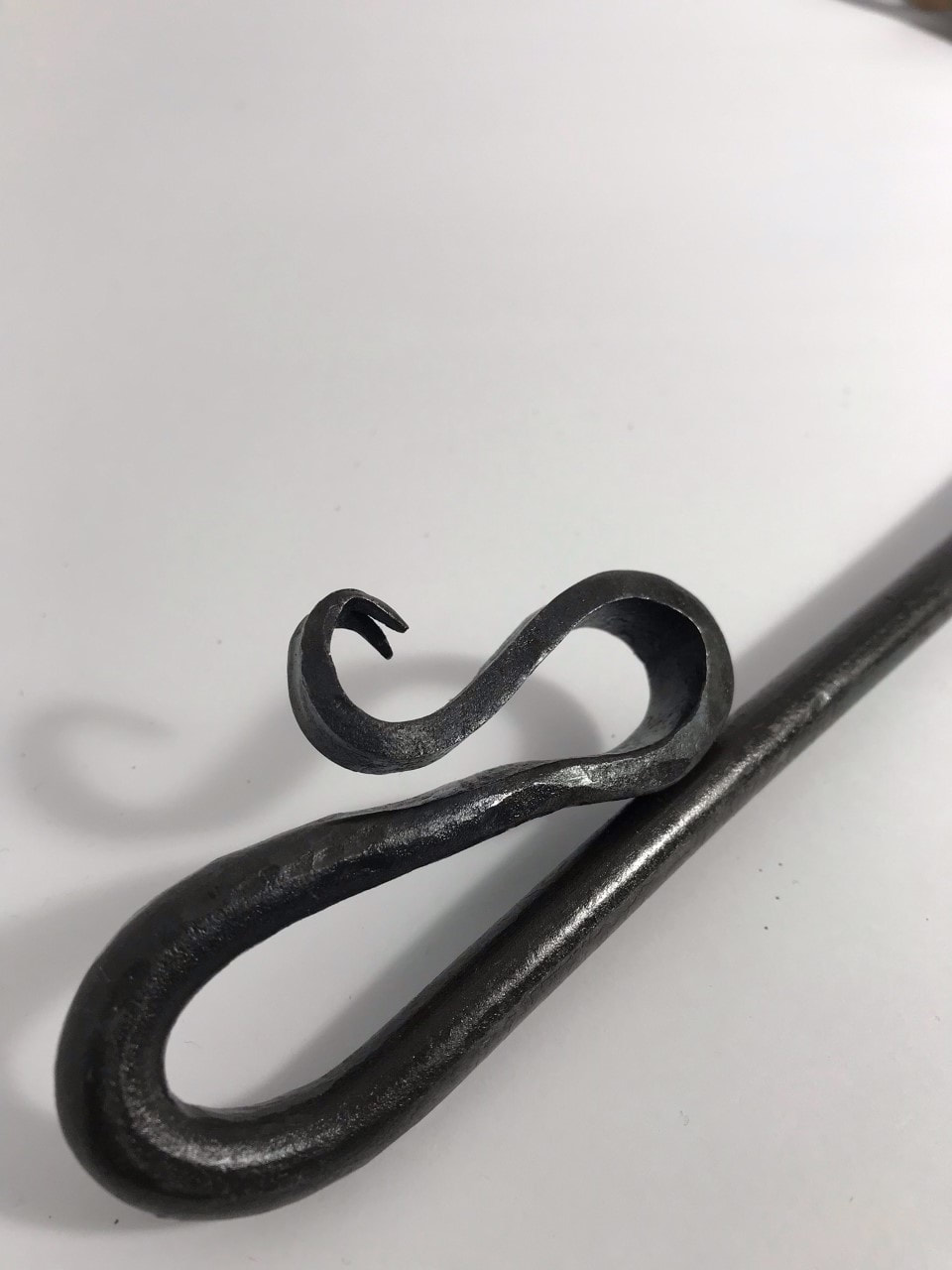 Blacksmith forged fire poker snake handle detail